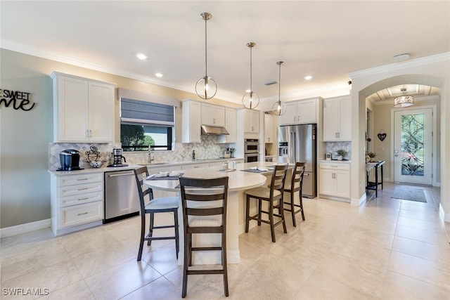 kitchen featuring appliances with stainless steel finishes, pendant lighting, white cabinetry, and a healthy amount of sunlight