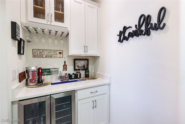 bar with white cabinetry and beverage cooler