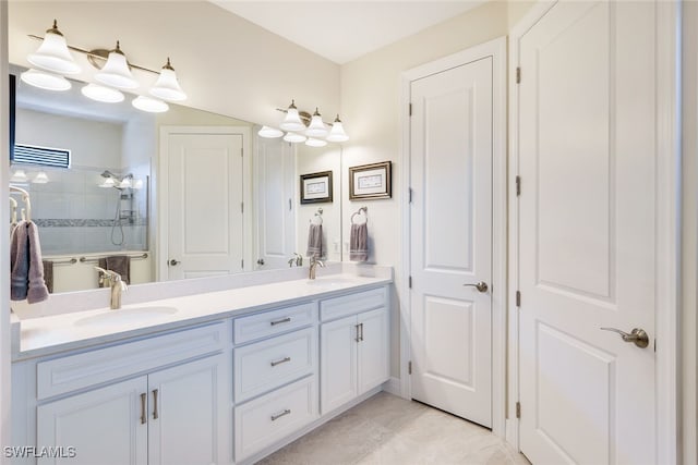 bathroom featuring vanity and tiled shower