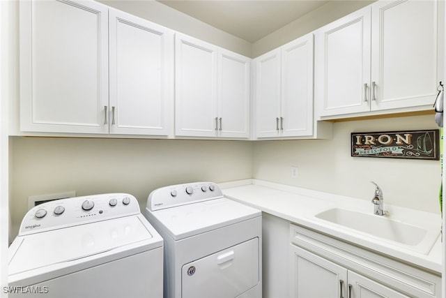 washroom featuring separate washer and dryer, sink, and cabinets