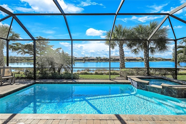 view of pool featuring an in ground hot tub, a water view, and glass enclosure