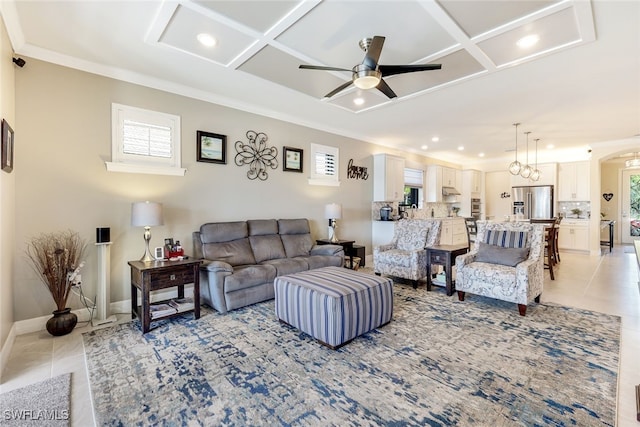 living room featuring ceiling fan, crown molding, light tile patterned floors, and coffered ceiling