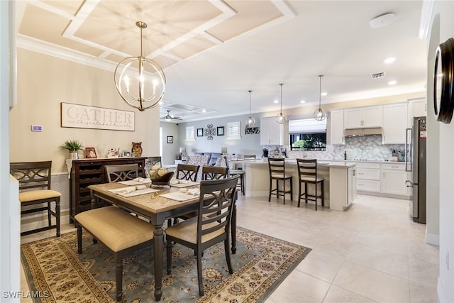 tiled dining room featuring crown molding and ceiling fan with notable chandelier