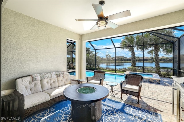 view of patio with a water view, glass enclosure, an outdoor living space with a fire pit, and a pool with hot tub