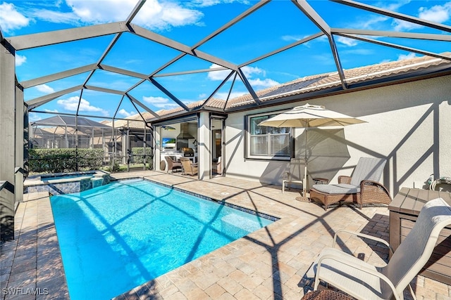 view of pool with a lanai, a patio area, and an in ground hot tub