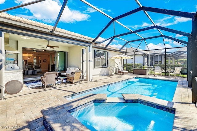 view of swimming pool featuring outdoor lounge area, ceiling fan, a lanai, and a patio