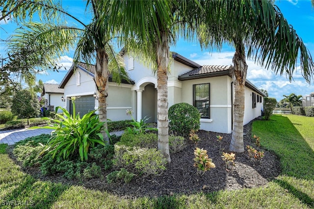 view of front facade with a garage and a front yard