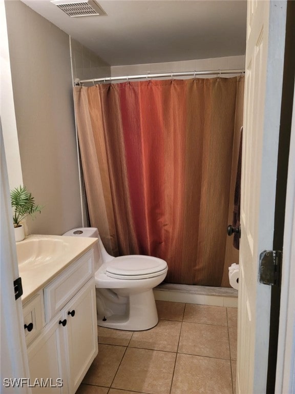 bathroom featuring vanity, toilet, tile patterned floors, and curtained shower