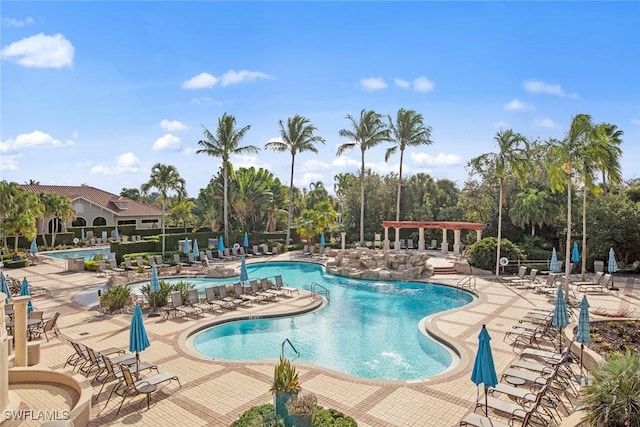 view of swimming pool featuring a patio area and pool water feature