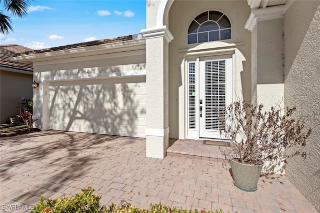 view of exterior entry with a garage