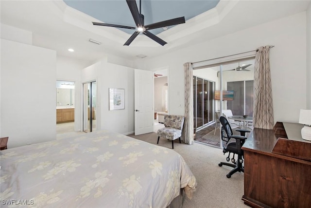 carpeted bedroom featuring ceiling fan, access to exterior, ensuite bathroom, and a tray ceiling