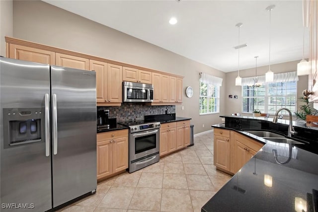 kitchen featuring light brown cabinets, sink, appliances with stainless steel finishes, tasteful backsplash, and decorative light fixtures