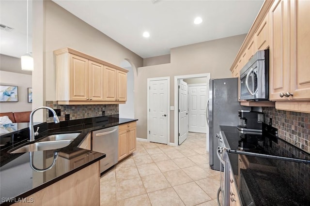 kitchen with sink, stainless steel appliances, and light brown cabinetry