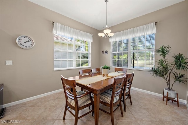 tiled dining area with a notable chandelier and a wealth of natural light