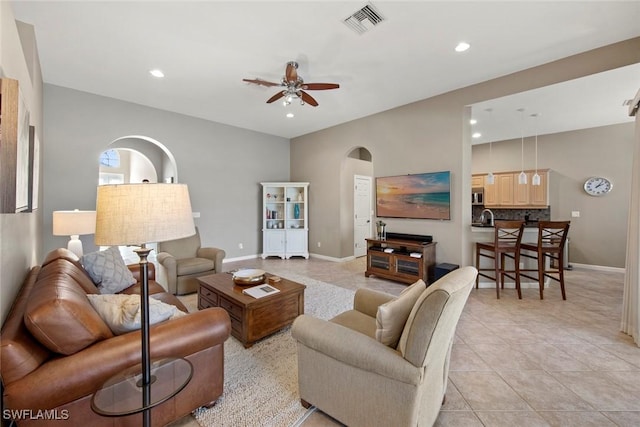 living room with ceiling fan and light tile patterned flooring