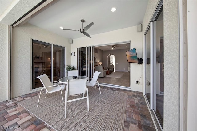 exterior space featuring ceiling fan