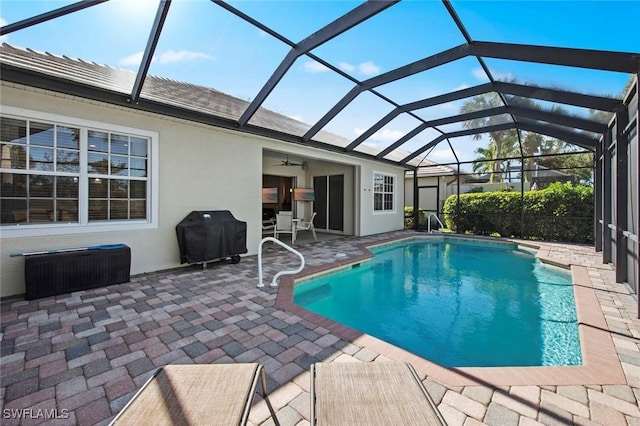 view of pool featuring a patio, area for grilling, ceiling fan, and a lanai