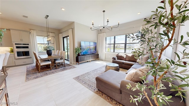 living room with an inviting chandelier and light tile patterned floors