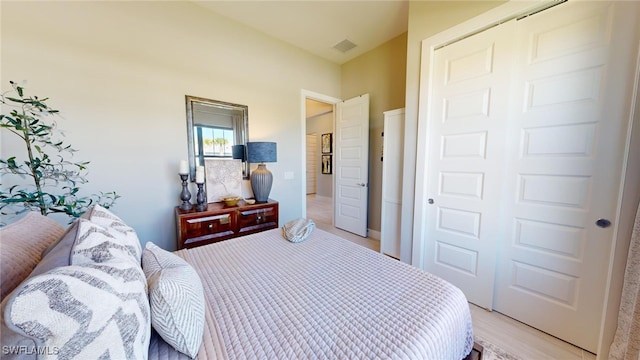 bedroom featuring a closet and light hardwood / wood-style flooring