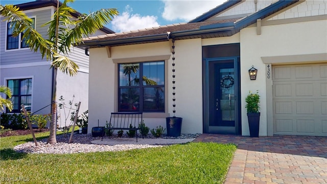 entrance to property with a yard and a garage