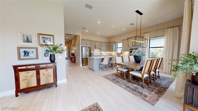 tiled dining area with a chandelier