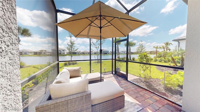 sunroom / solarium featuring a water view