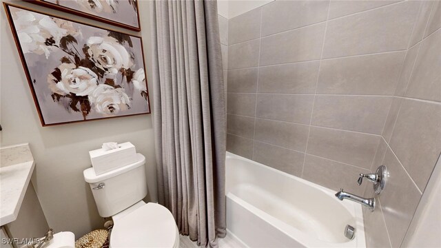 bathroom with toilet and shower / tub combo with curtain