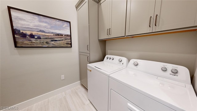 laundry room featuring cabinets and independent washer and dryer