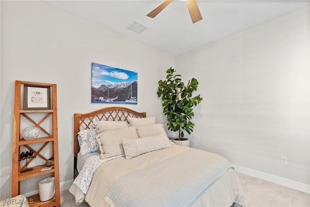 tiled bedroom featuring ceiling fan