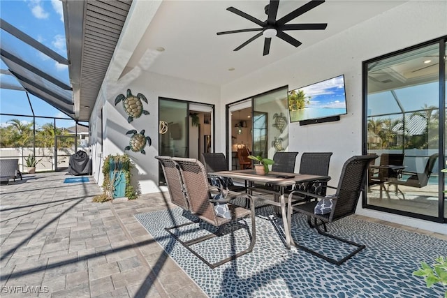 view of patio / terrace with ceiling fan and a lanai