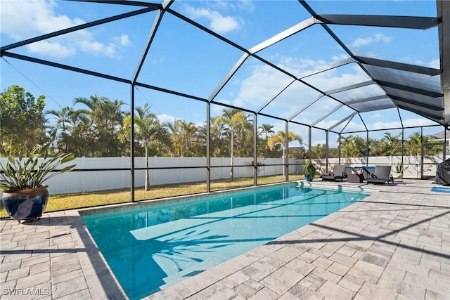 view of swimming pool with a lanai and a patio