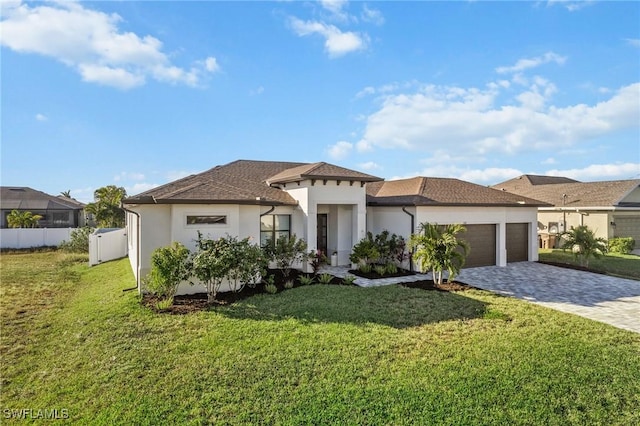 view of front of house featuring a garage and a front lawn