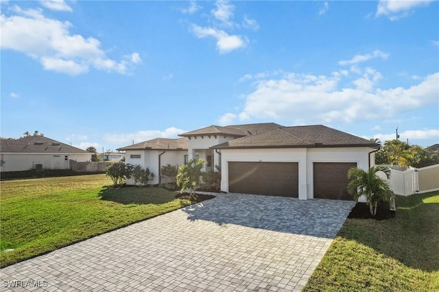 view of front of property featuring a garage and a front lawn