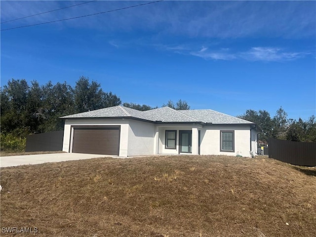 view of front of home with a garage and a front lawn