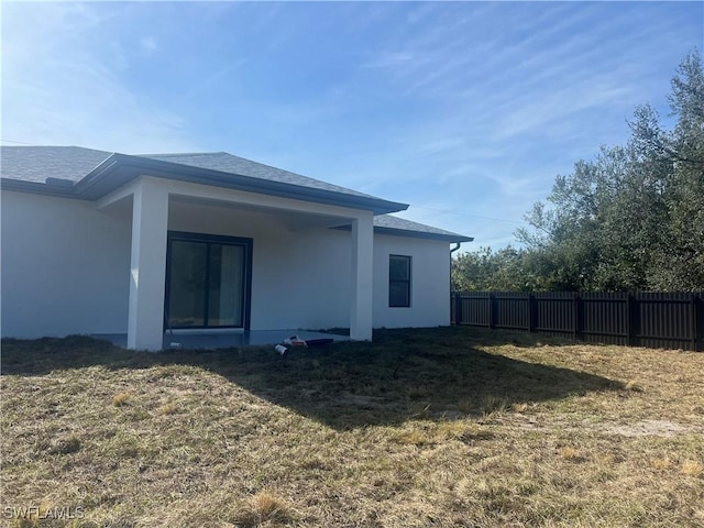 rear view of property with a lawn