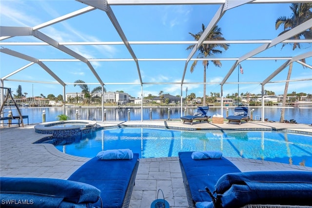 view of swimming pool featuring an in ground hot tub, a water view, and a lanai