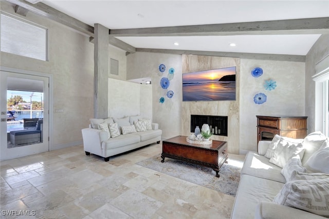 living room featuring a fireplace and lofted ceiling with beams