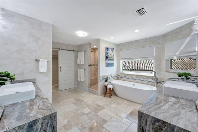 bathroom with separate shower and tub, tile walls, and sink