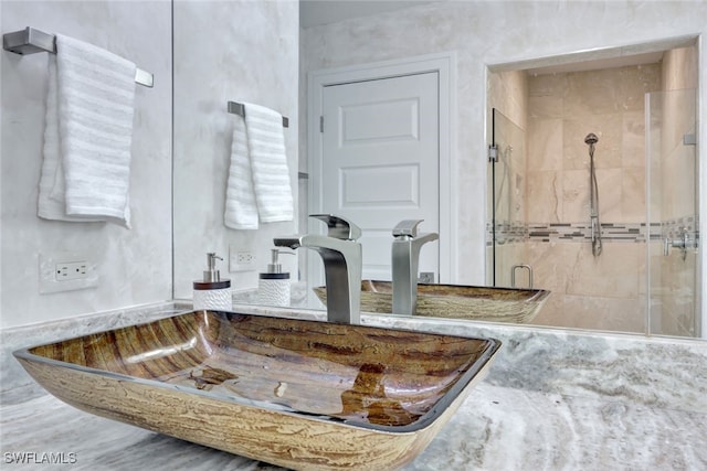 bathroom with sink and an enclosed shower