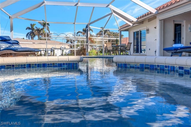 view of pool with glass enclosure