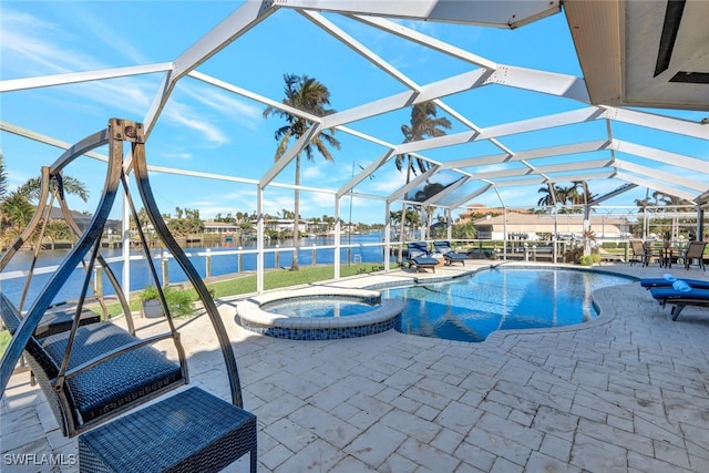 view of swimming pool featuring glass enclosure, a patio area, a water view, and an in ground hot tub