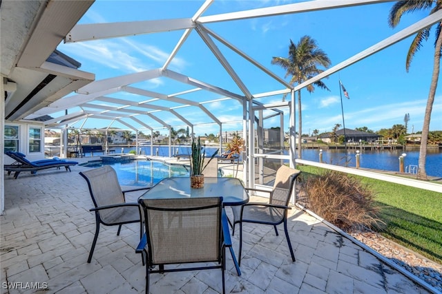 view of patio with a water view and a lanai