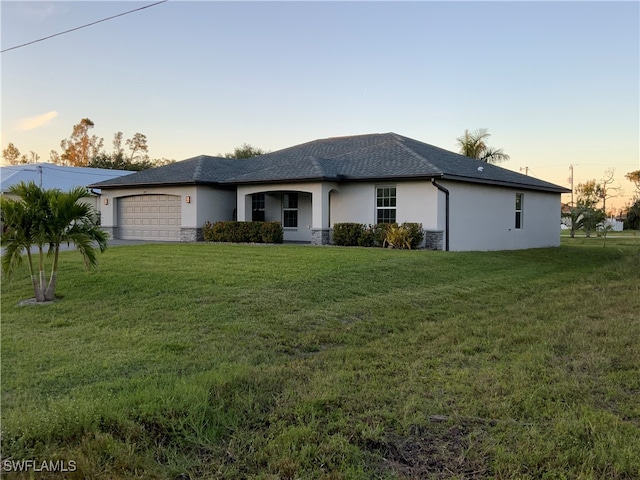 ranch-style home with a lawn and a garage