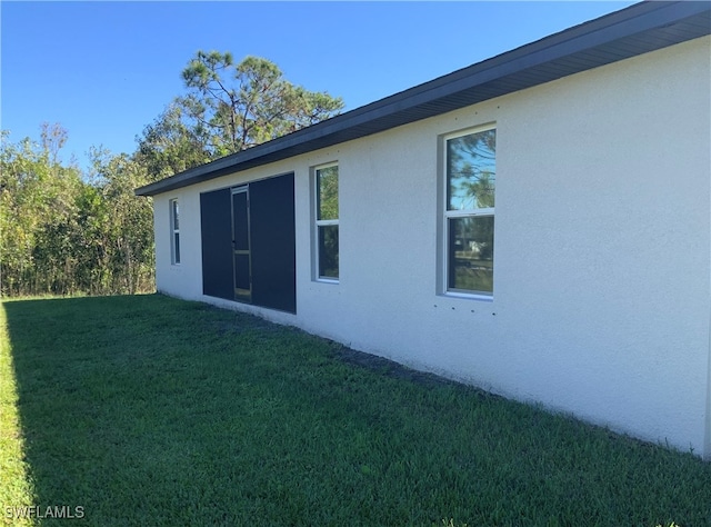 view of side of property with a lawn