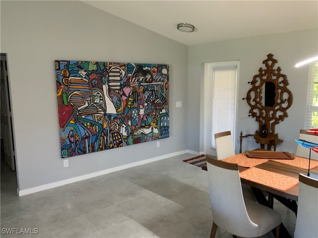 dining room featuring lofted ceiling