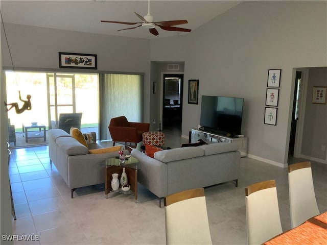 living room with ceiling fan, high vaulted ceiling, and light tile patterned floors