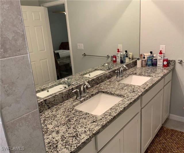 bathroom featuring tile patterned flooring and vanity