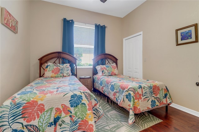 bedroom with ceiling fan and dark hardwood / wood-style flooring