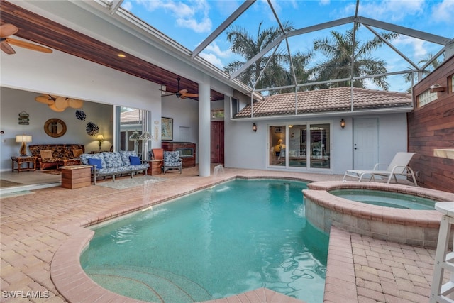 view of pool with ceiling fan, a patio, an outdoor hangout area, pool water feature, and an in ground hot tub