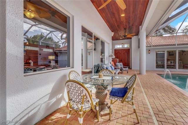 exterior space featuring ceiling fan and wooden ceiling